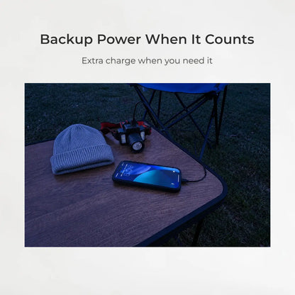 Phone with power bank on a table outdoors, with text 'Backup Power When It Counts'.