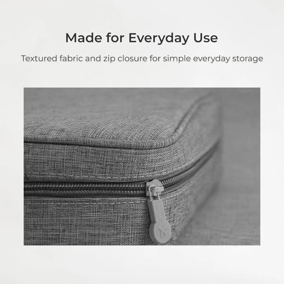 Gray textured fabric storage case with zip closure on a light gray background