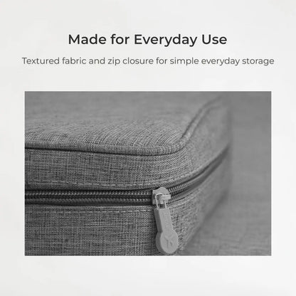 Gray textured fabric storage case with zip closure on a light gray background